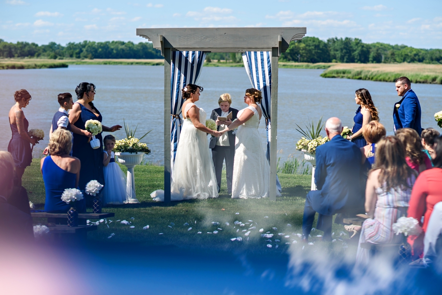A lesbian couple getting married on the waterfront of the jersey shore.